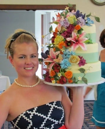 Kate holds a three-tiered cake